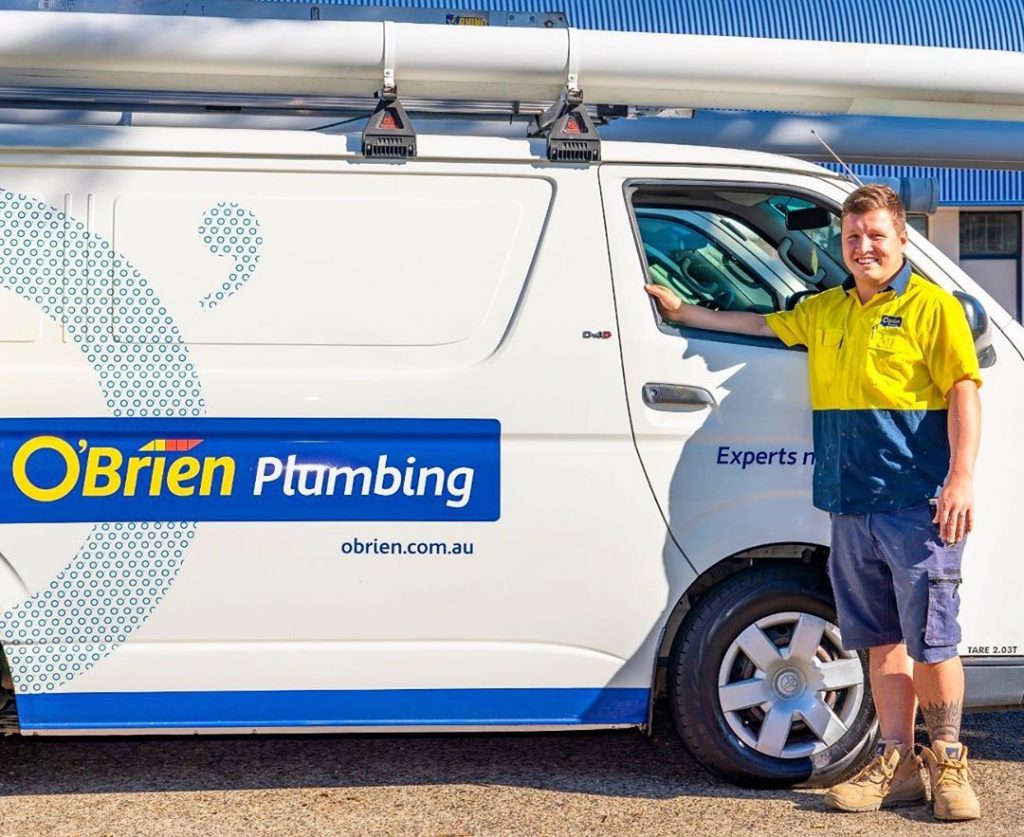 plumber in Coffs Harbour standing next to O'Brien Plumbing van