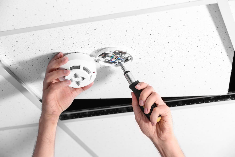 Man Installing Smoke Detector