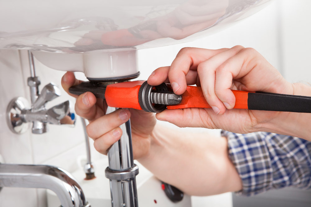 Plumber Fixing Sink Pipes