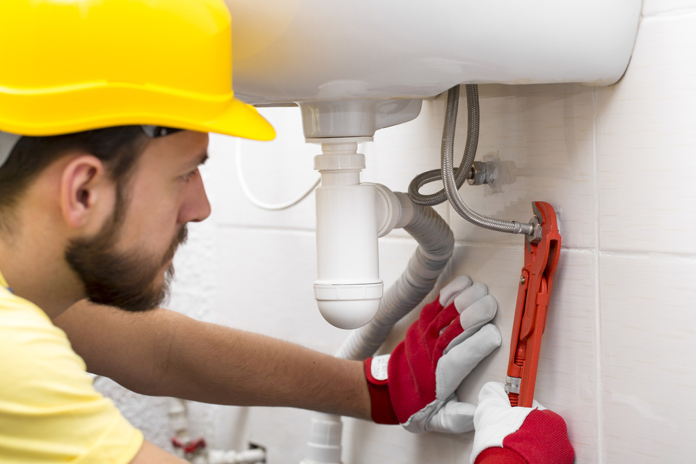 Plumber Fixing Sink Pipe