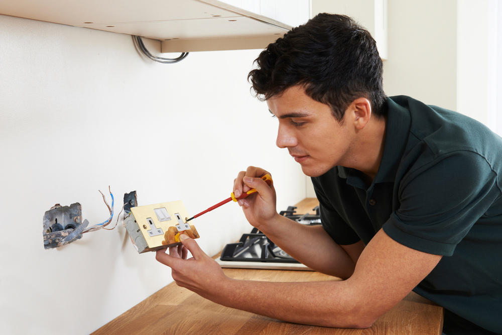 Electrician Installing Powerpoints In Kitchen
