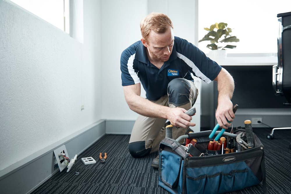 Commercial Electrician Repairing Outlet