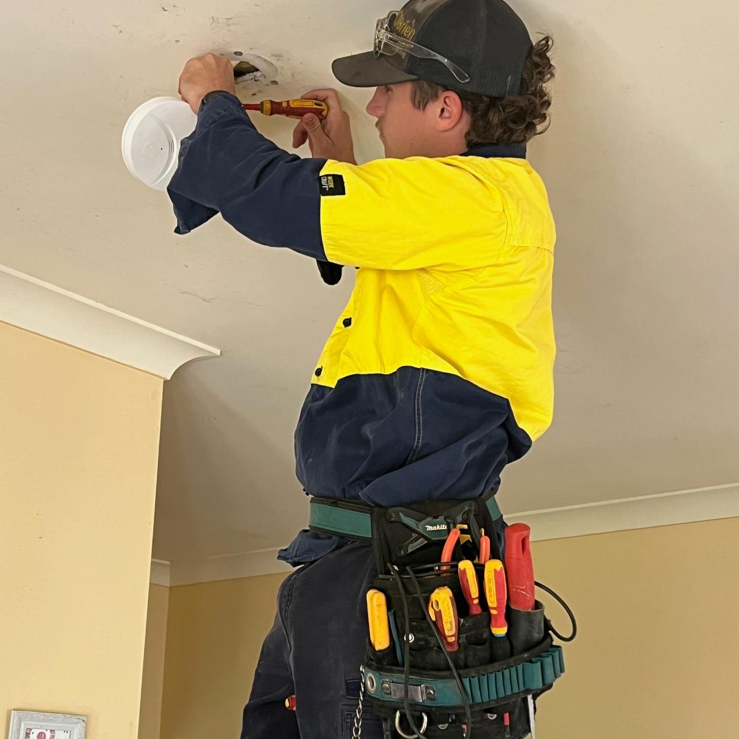 electricians port macquarie inspecting a smoke alarm