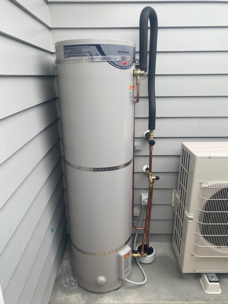 external electric hot water cylinder outside a house